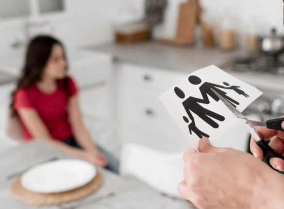 close-up-parent-cutting-paper-family-with-scissors.jpg
